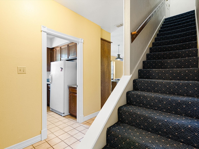 stairway featuring tile patterned floors