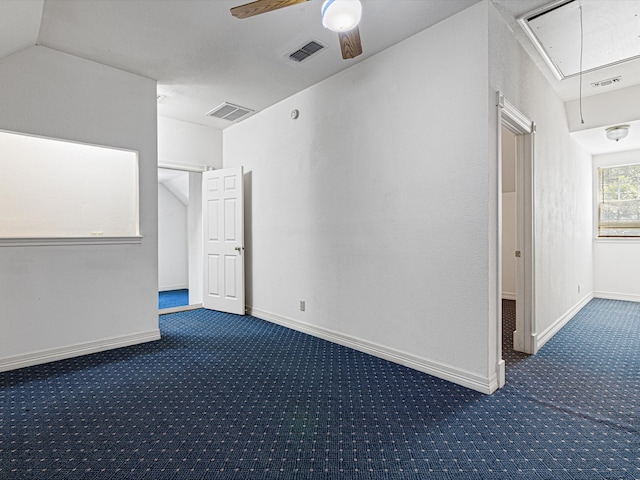 carpeted empty room with vaulted ceiling and ceiling fan