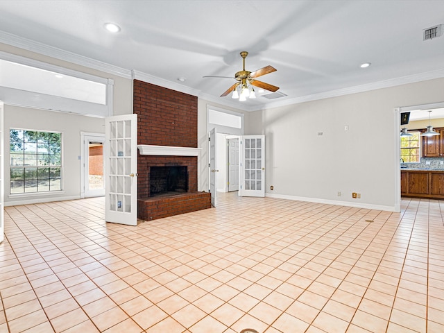 unfurnished living room featuring french doors, ornamental molding, ceiling fan, light tile patterned floors, and a fireplace