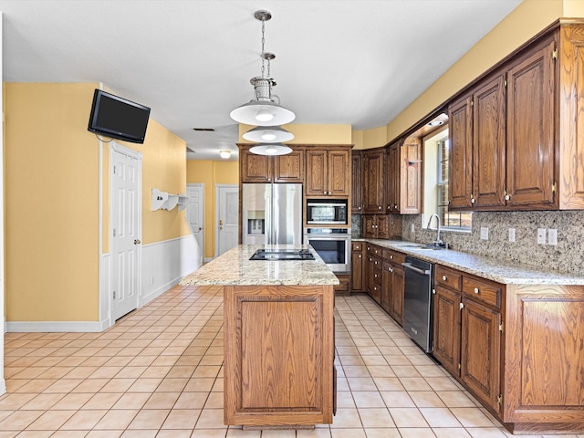 kitchen featuring a center island, hanging light fixtures, decorative backsplash, light tile patterned floors, and appliances with stainless steel finishes