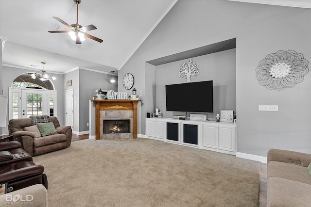 carpeted living room with ceiling fan with notable chandelier, high vaulted ceiling, ornamental molding, and a fireplace