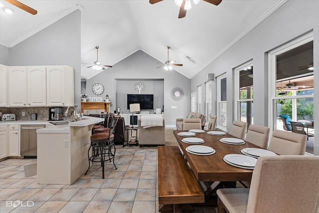 dining room featuring ceiling fan, light tile patterned floors, sink, and high vaulted ceiling