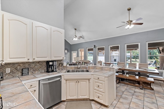 kitchen with ceiling fan, kitchen peninsula, stainless steel dishwasher, and light tile patterned floors