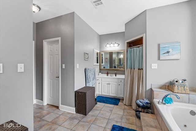 bathroom featuring a bathtub, tile patterned floors, and vanity