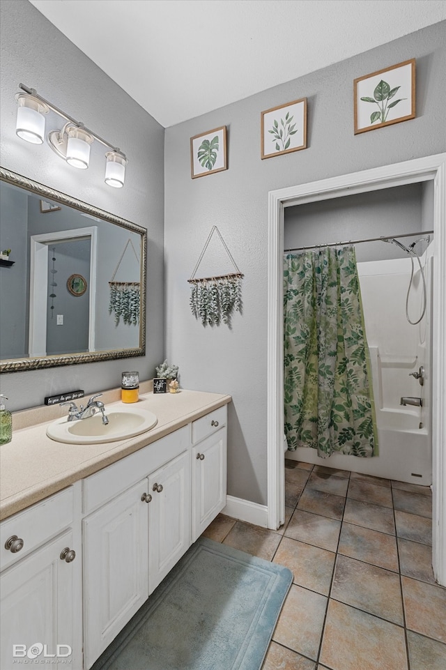 bathroom featuring tile patterned flooring, shower / bathtub combination with curtain, and vanity