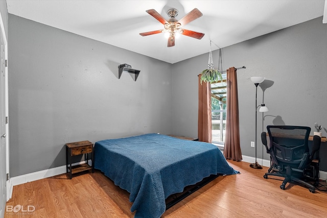 bedroom with light hardwood / wood-style floors and ceiling fan