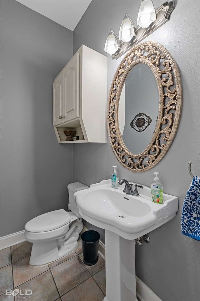 bathroom featuring toilet and tile patterned floors