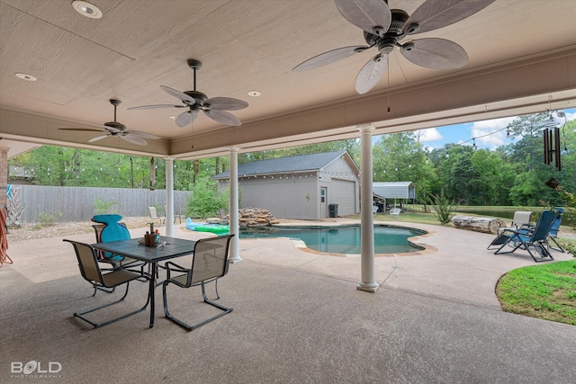 view of pool with ceiling fan, a storage shed, and a patio area