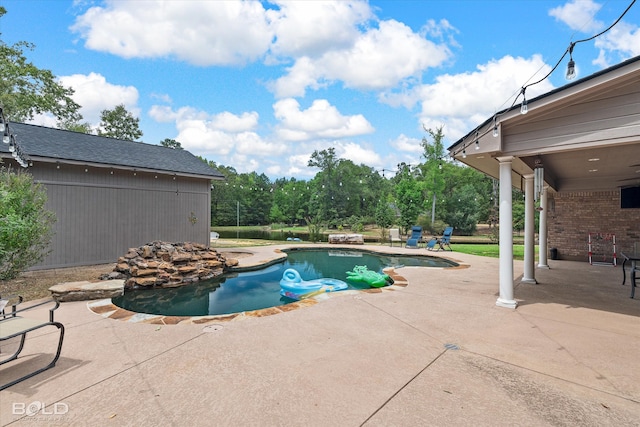 view of swimming pool with a patio area