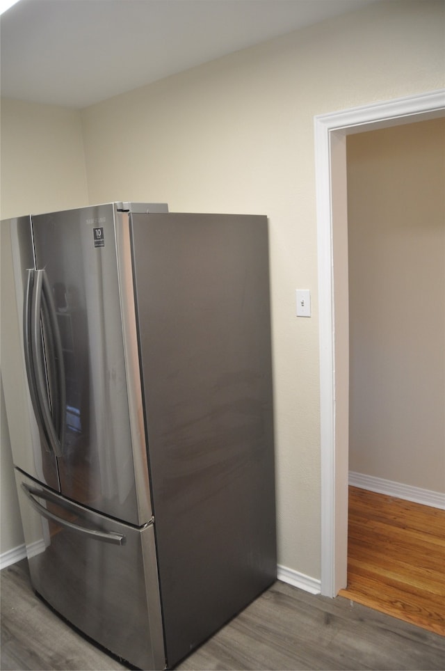 kitchen with wood-type flooring and stainless steel fridge