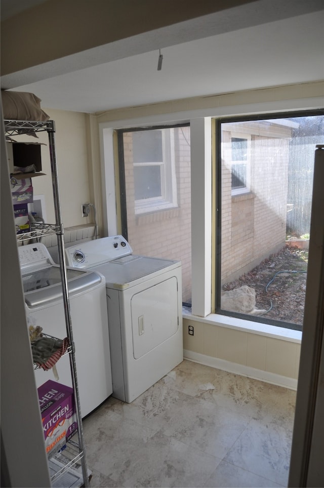 washroom with washing machine and clothes dryer