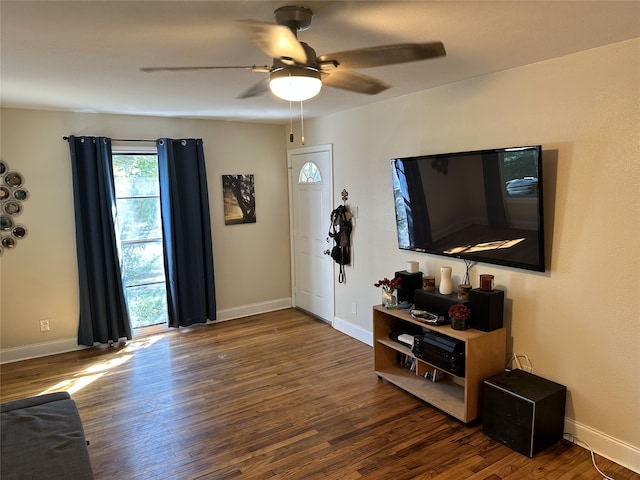 living room with ceiling fan and dark hardwood / wood-style flooring