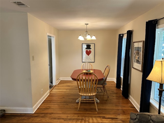 dining area with a chandelier, dark hardwood / wood-style floors, and plenty of natural light