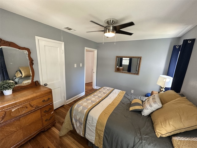 bedroom with ceiling fan and dark hardwood / wood-style flooring