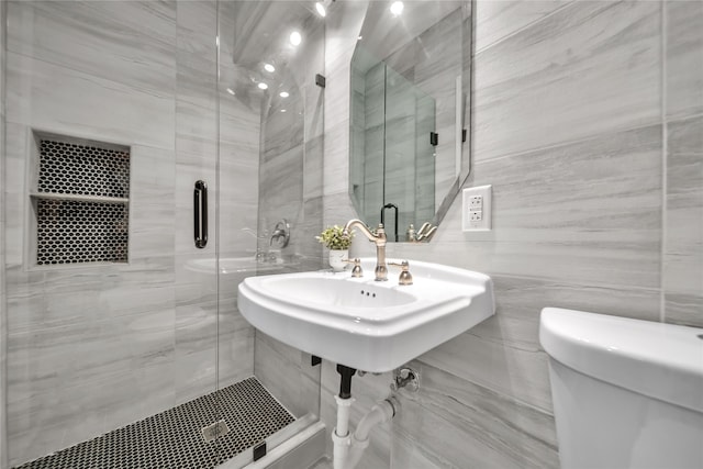 bathroom featuring tile walls, toilet, and an enclosed shower