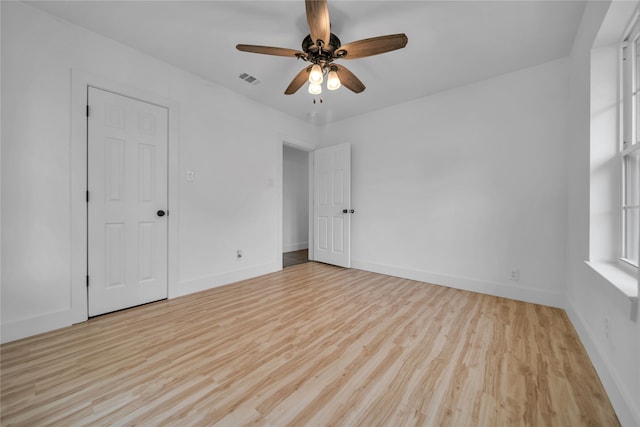 spare room featuring hardwood / wood-style flooring and ceiling fan