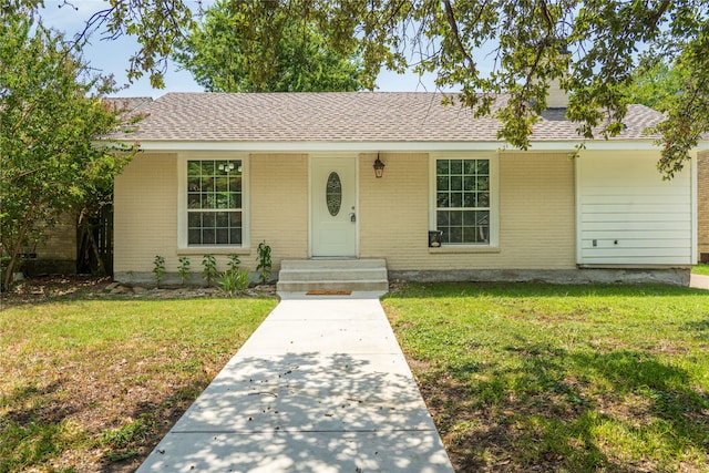 ranch-style home with a front yard and covered porch