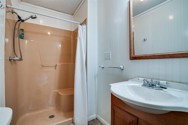 bathroom with curtained shower, a textured ceiling, and vanity