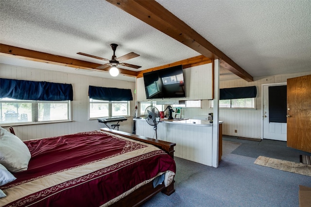 carpeted bedroom with a textured ceiling, beam ceiling, and ceiling fan