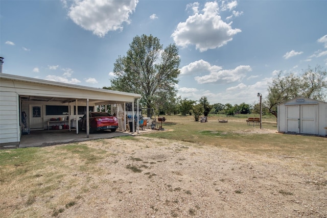 view of yard featuring a storage shed and a carport