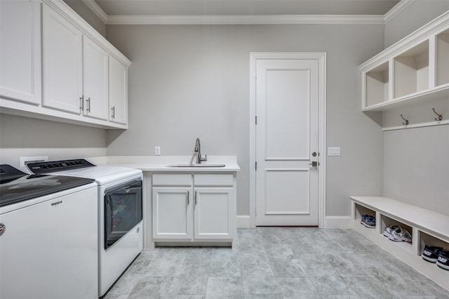 laundry area featuring ornamental molding, washer and dryer, cabinets, and sink