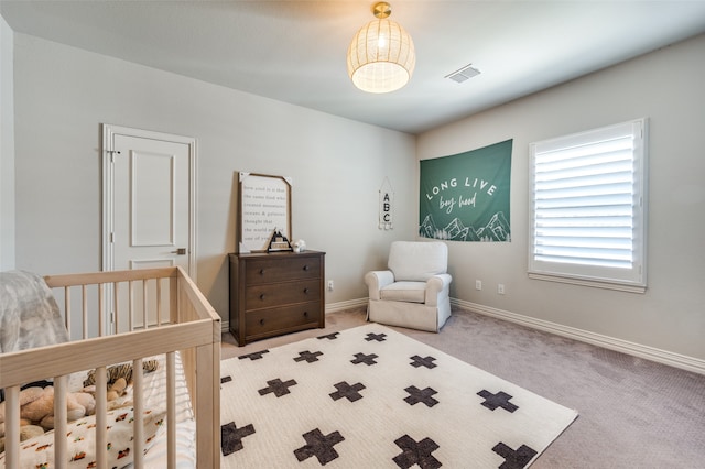 bedroom with carpet floors and a crib