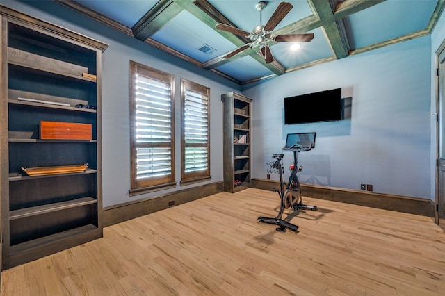 exercise area with coffered ceiling, ceiling fan, wood-type flooring, and ornamental molding