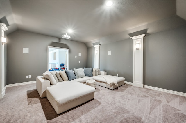 carpeted living room featuring lofted ceiling and decorative columns