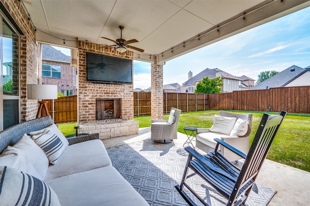 view of patio featuring ceiling fan and an outdoor living space with a fireplace