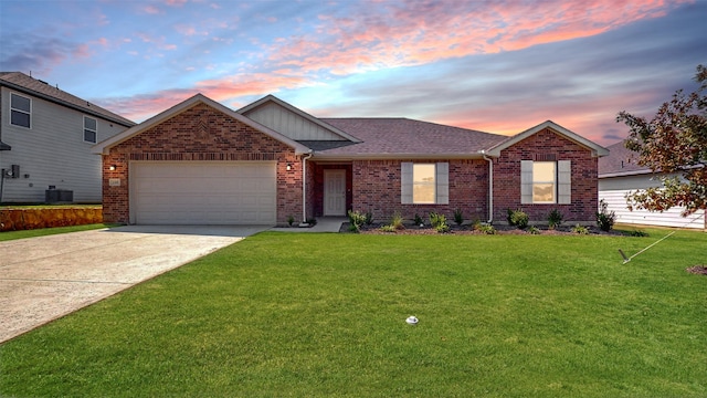 view of front facade with a garage, a lawn, and central AC unit