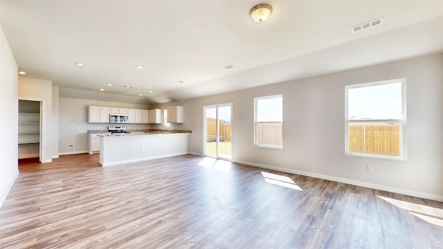 unfurnished living room with light hardwood / wood-style flooring