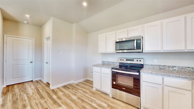 kitchen featuring stainless steel appliances, light stone countertops, light hardwood / wood-style flooring, and white cabinetry