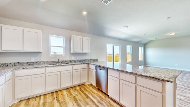 kitchen with white cabinets, lofted ceiling, kitchen peninsula, dishwasher, and light hardwood / wood-style floors