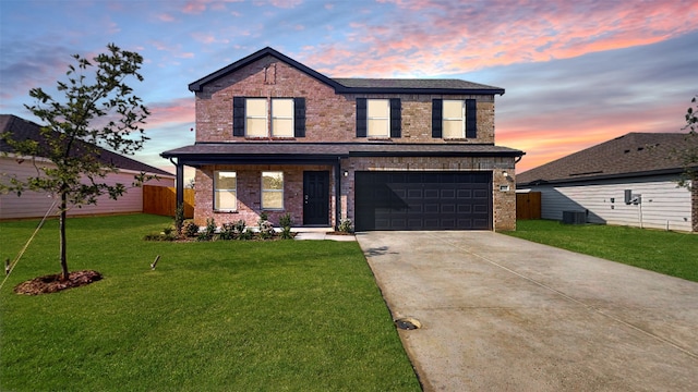 front facade with a garage, a porch, and a yard