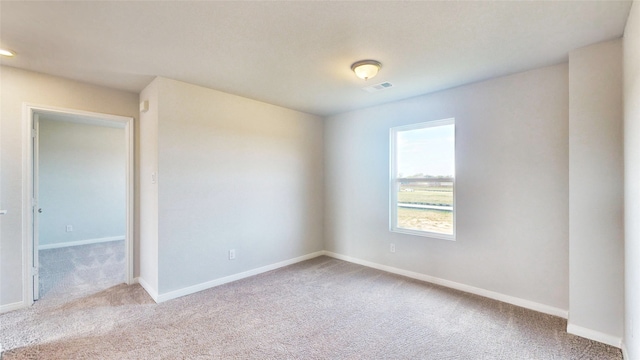 unfurnished room featuring light colored carpet