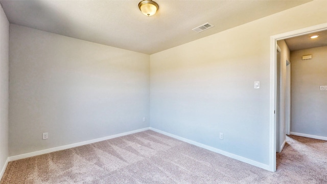 empty room featuring light carpet