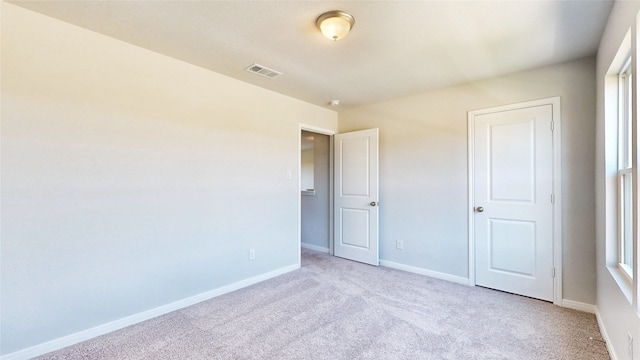 unfurnished bedroom with light colored carpet