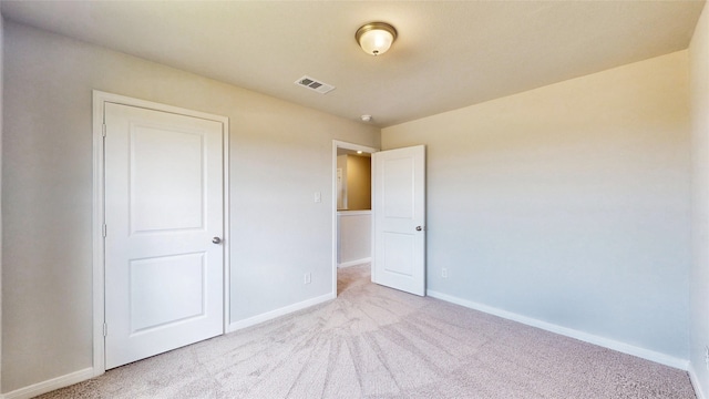 unfurnished bedroom featuring light carpet