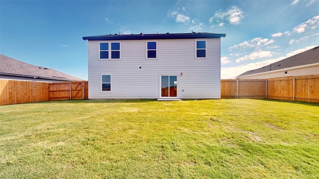 rear view of house with a yard