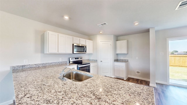 kitchen featuring white cabinets, stainless steel appliances, dark hardwood / wood-style floors, and sink