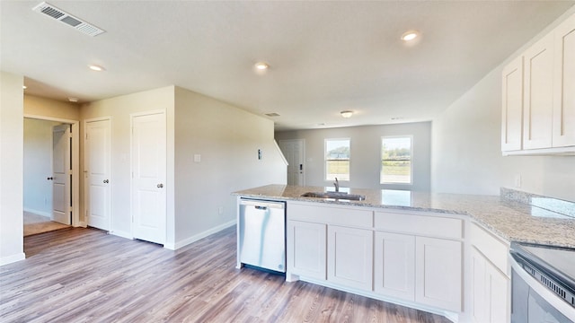 kitchen featuring white cabinets, appliances with stainless steel finishes, kitchen peninsula, and light hardwood / wood-style flooring