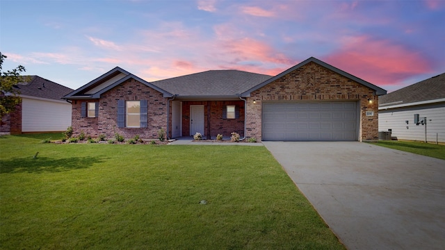 view of front of house featuring a garage and a lawn