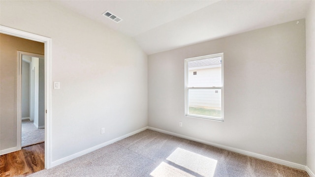 empty room with lofted ceiling and dark wood-type flooring