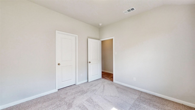 unfurnished bedroom with light colored carpet