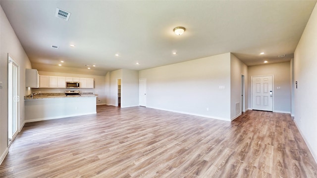 unfurnished living room with light hardwood / wood-style flooring