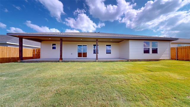 back of house featuring a yard and a patio area