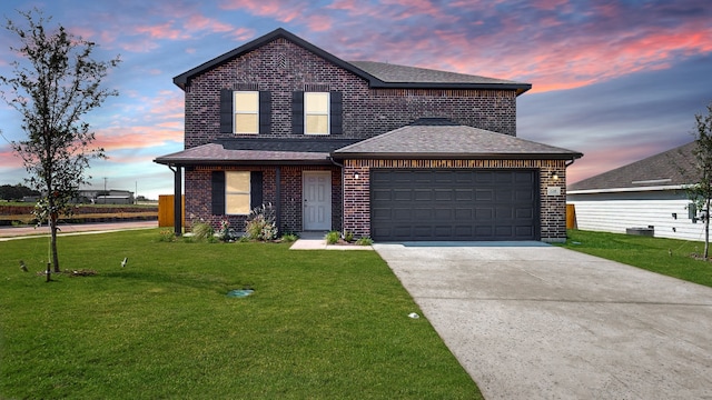 view of front of house with a garage and a yard