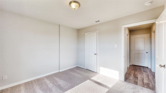 unfurnished bedroom featuring wood-type flooring and a closet