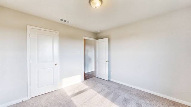 unfurnished bedroom with light carpet