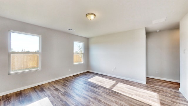 empty room with hardwood / wood-style flooring